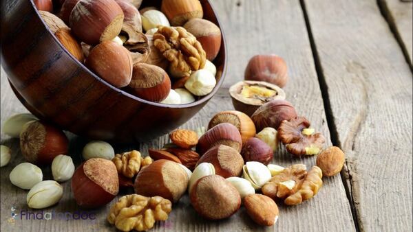 Granola and fruit in a small bowl on a wooden table